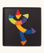 A dancing clown made from the Grimm's bright wooden Goethe magnetic pieces displayed in a tin 