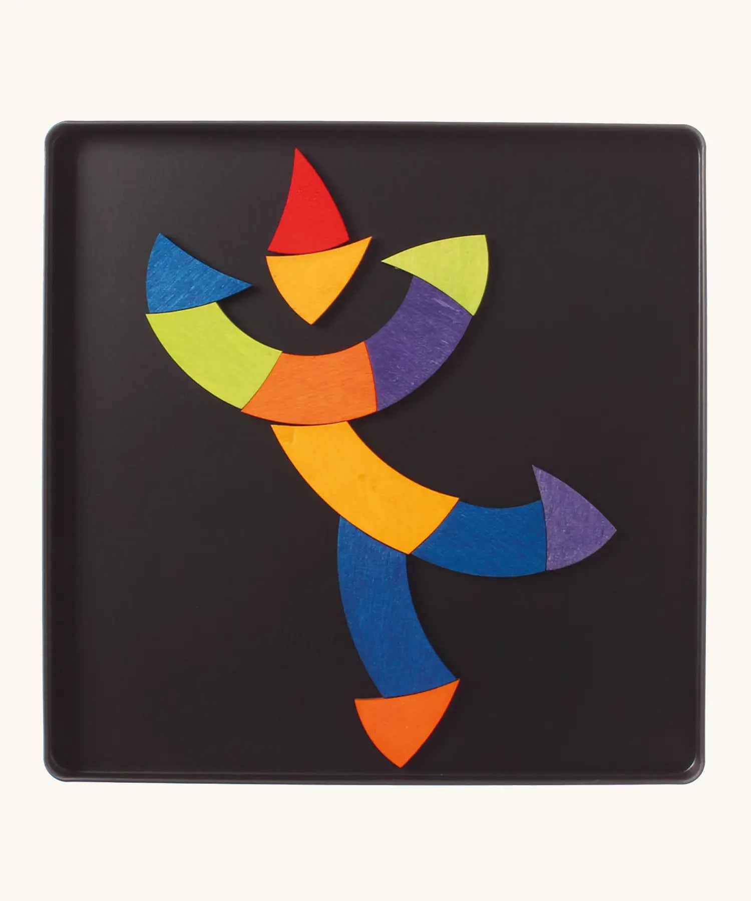 A dancing clown made from the Grimm's bright wooden Goethe magnetic pieces displayed in a tin 