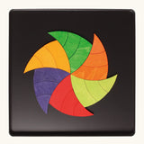 A abstract swirl made from the Grimm's bright wooden Goethe magnetic pieces displayed in a tin 