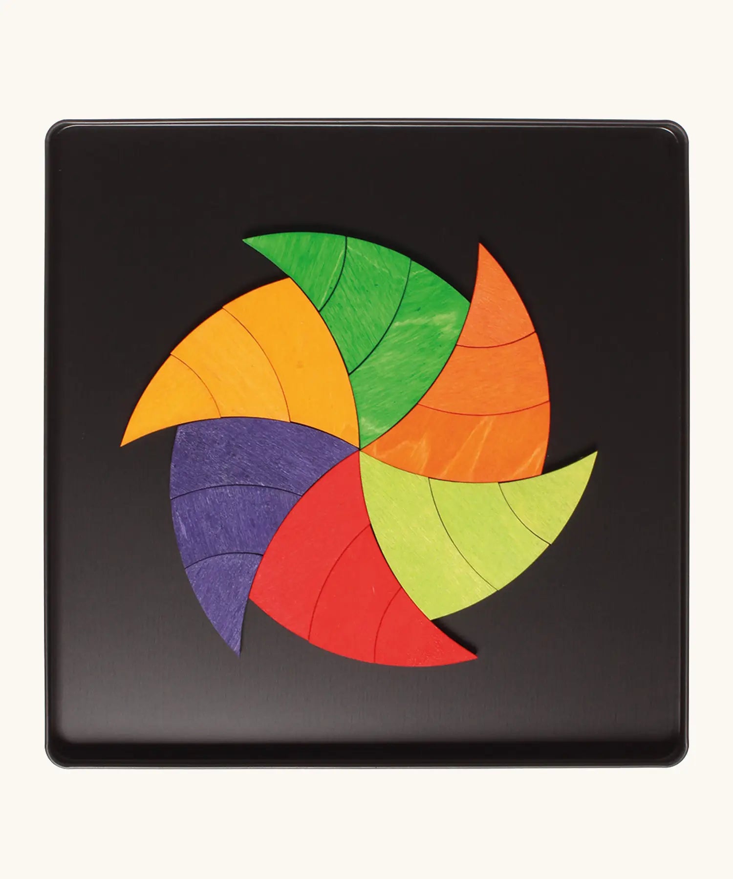 A abstract swirl made from the Grimm's bright wooden Goethe magnetic pieces displayed in a tin 