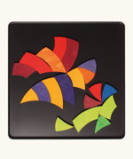 A bee in flight made from the Grimm's bright wooden Goethe magnetic pieces displayed in a tin 
