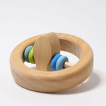 The Grimm's baby Grasping Toy Little Fish With Wooden Discs laid flat with the fish at the center pointing up.