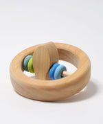The Grimm's baby Grasping Toy Little Fish With Wooden Discs laid flat with the fish at the center pointing up.