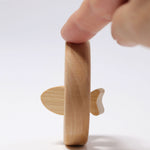 A side profile photo of the Grimm's baby Grasping Toy Little Fish With Wooden Discs.
