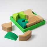 Grimm's green squirrel Building Set. Wooden blocks in various shades of green and natural wood in a green coloured wooden storage tray. These Grimm's toys are part of a wide range of wooden toys available here at Babipur. 