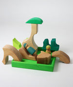 A small world play scene created using the pieces from the Grimm's green squirrel building set with friends wooden peg dolls. These Grimm's toys are part of a wide range of wooden toys available here at Babipur. 