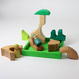 A small world play scene created using the pieces from the Grimm's green squirrel building set with friends wooden peg dolls. These Grimm's toys are part of a wide range of wooden toys available here at Babipur. 