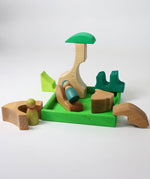 A small world play scene created using the pieces from the Grimm's green squirrel building set with friends wooden peg dolls. These Grimm's toys are part of a wide range of wooden toys available here at Babipur. 