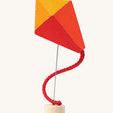 Grimm's Kite Decorative Figure, a red orange and yellow coloured kite to fit onto the Grimm's celebration ring. These Waldorf inspired decorative figures are part of a wide range of wooden decorations for celebration rings available here at Babipur. 