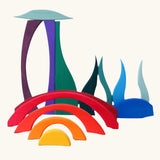 Blocks from Grimm's landscape puzzle wooden toy set stacked to create a scene. 