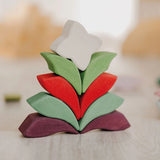 Grimm's Lara Mandala Building Set blocks used to create a flower shaped stack.