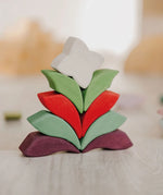 Grimm's Lara Mandala Building Set blocks used to create a flower shaped stack.