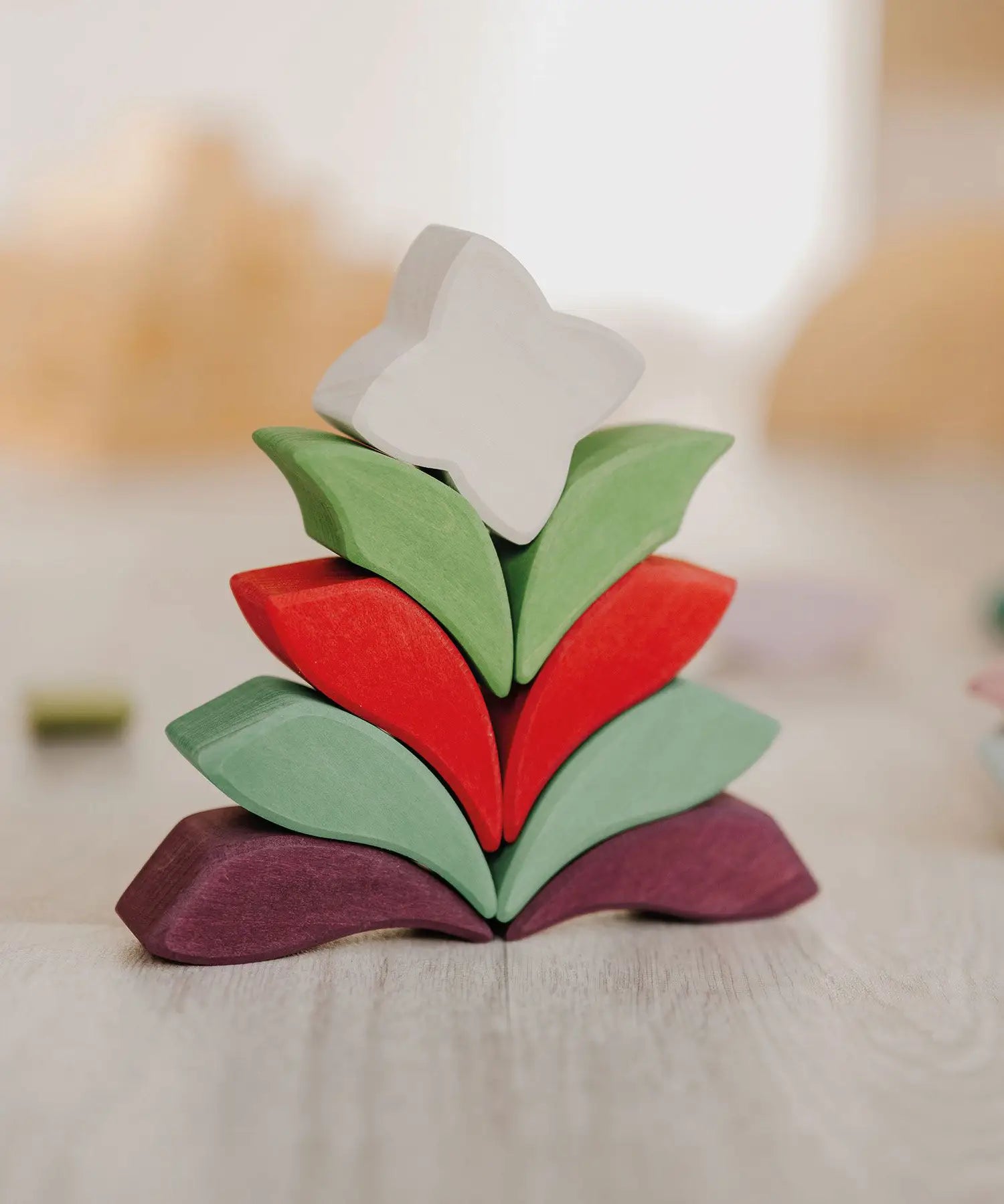 Grimm's Lara Mandala Building Set blocks used to create a flower shaped stack.