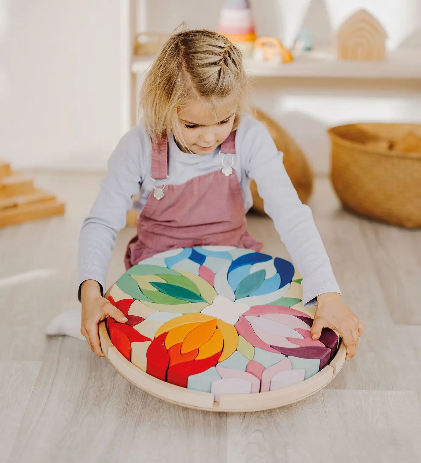 Grimm's Lara Mandala Building Set being picked up by a child.