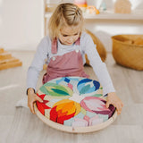 Grimm's Lara Mandala Building Set being picked up by a child.