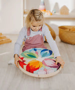 Grimm's Lara Mandala Building Set being picked up by a child.