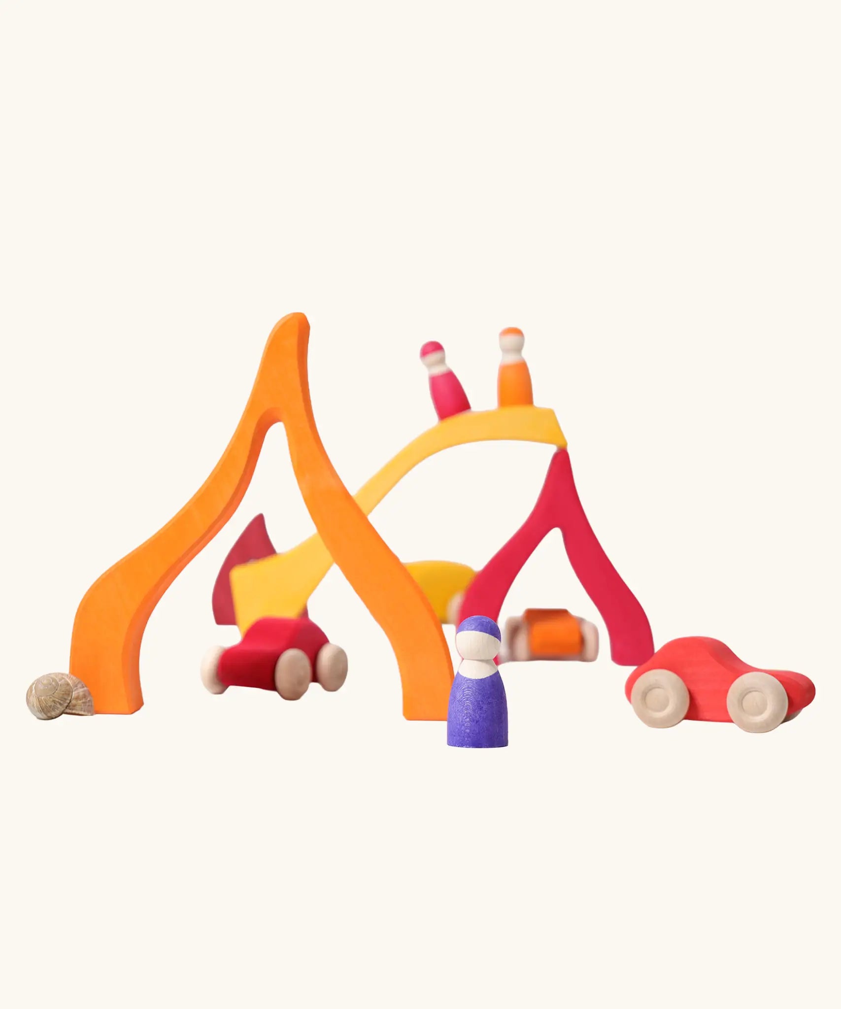 Fire elements from the Grimm's Large 4 Elements wooden Building Set used in a small world play set up with Grimm's friends and cars.
