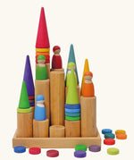 Grimm's large wooden building rollers in natural in a tray with coins, peg dolls and Grimm's forest pieces placed on them.