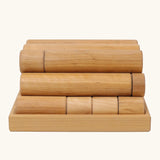 Side view of the Grimm's large wooden building rollers in natural in a tray.