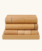 Side view of the Grimm's large wooden building rollers in natural in a tray.