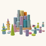 Grimm's large building rollers pastel in a wooden storage tray surrounded by other wooden Grimm's pastel toys.