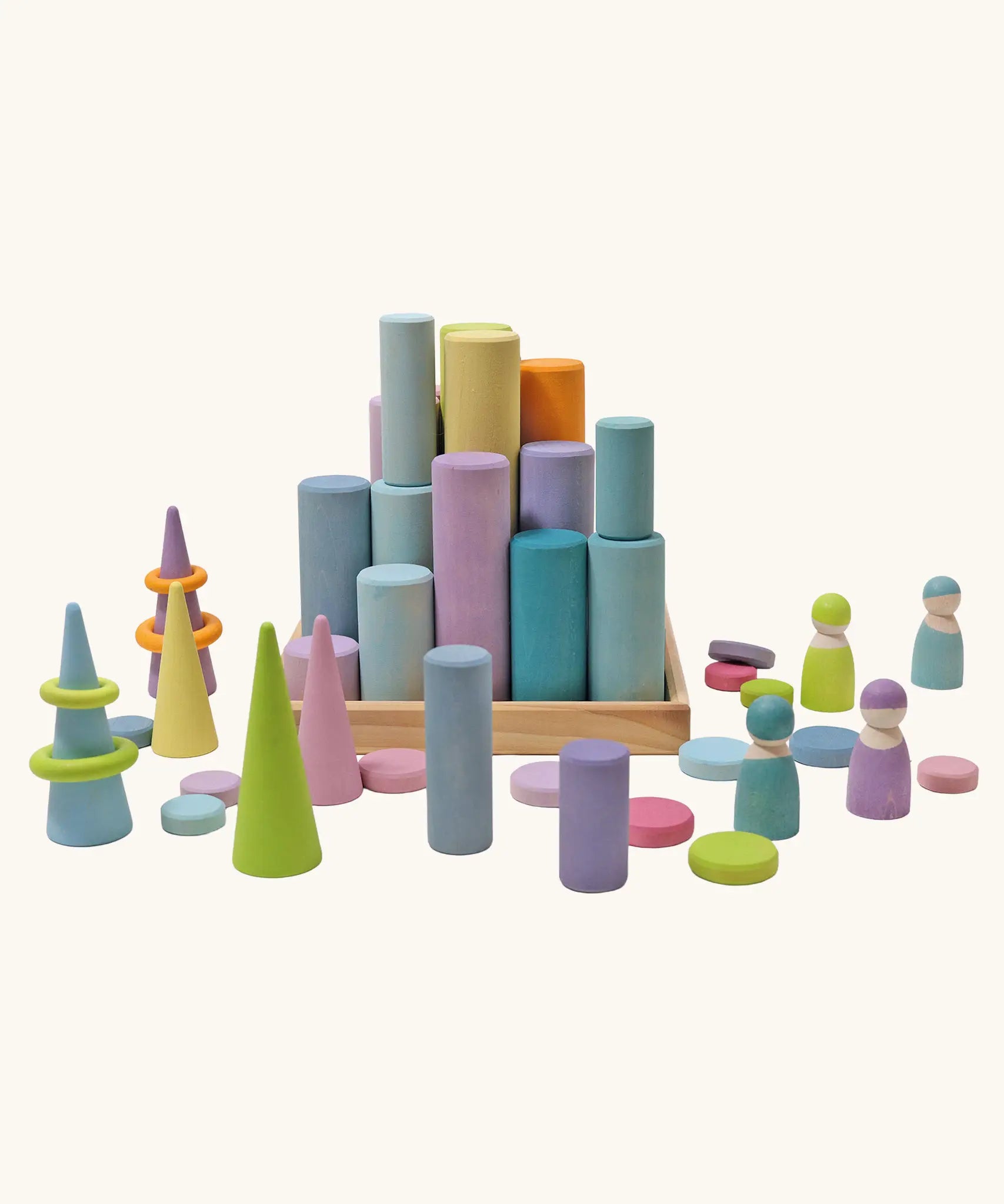 Grimm's large building rollers pastel in a wooden storage tray surrounded by other wooden Grimm's pastel toys.