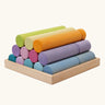 Grimm's large building rollers pastel in a wooden storage tray.