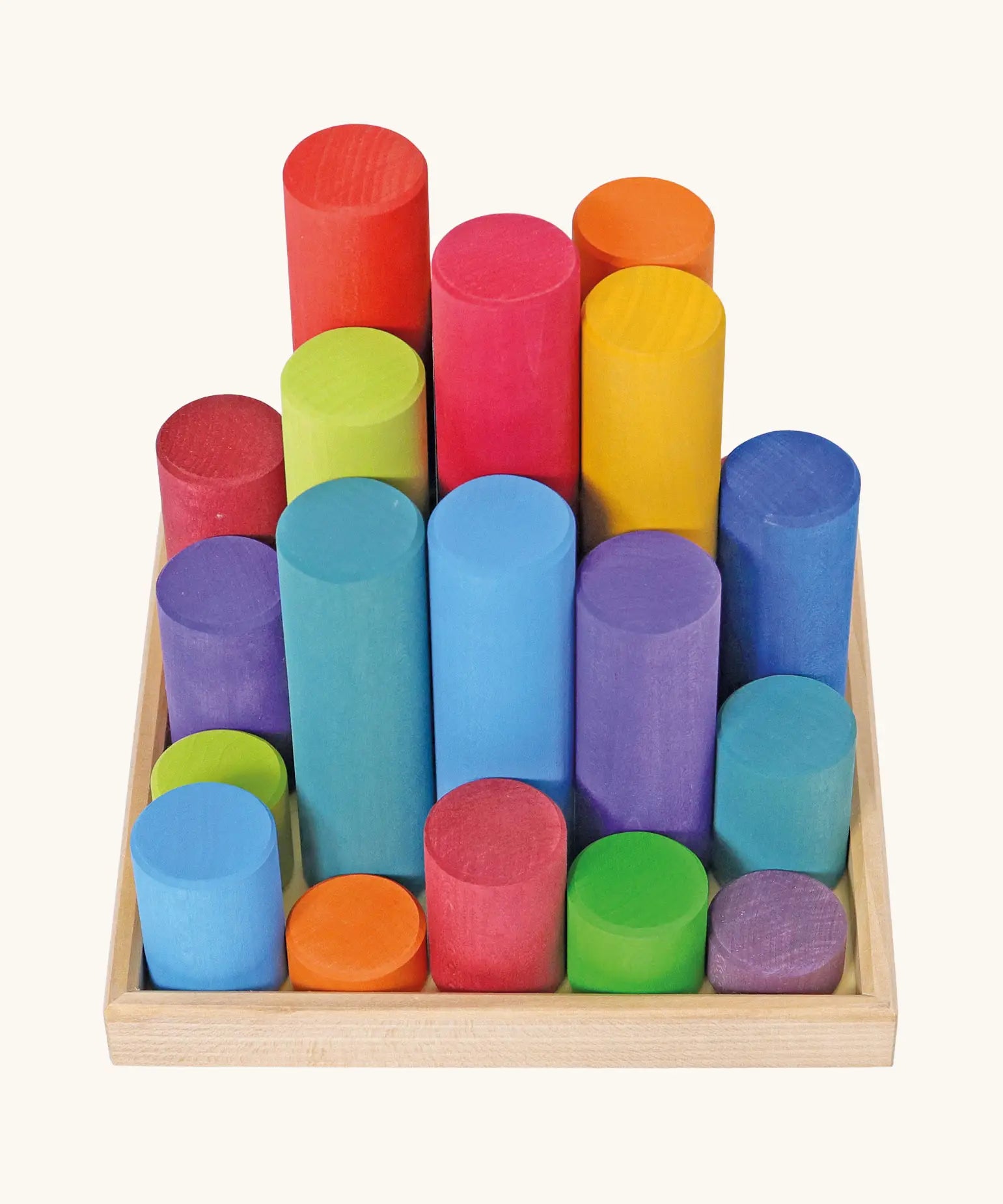 Grimm's large building rollers in bright rainbow colours in a wooden storage tray.