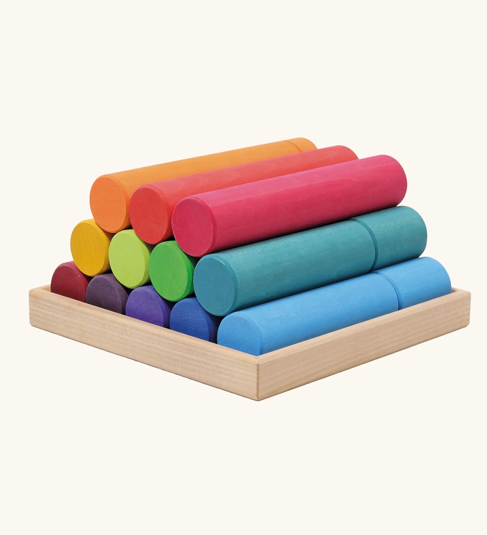Grimm's large building rollers in bright rainbow colours in a wooden storage tray.