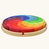 Grimm's Large Colour Spiral in a wooden tray, side view.