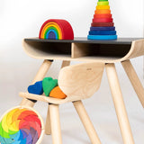 A display showing different Grimms stacking toys including the large conical tower