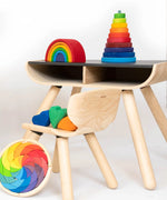 A display showing different Grimms stacking toys including the large conical tower