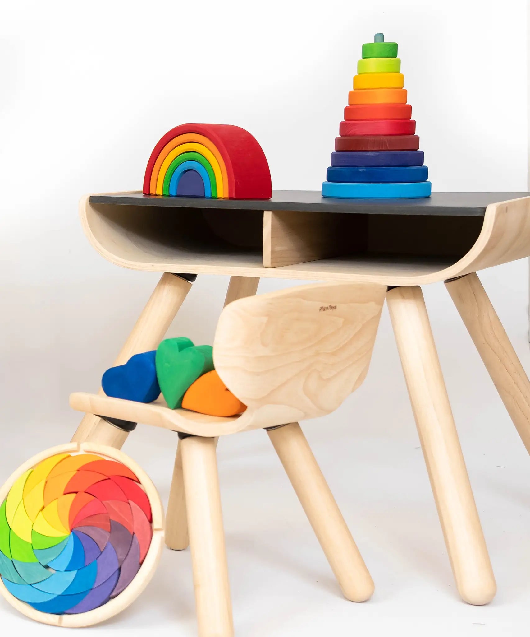 A display showing different Grimms stacking toys including the large conical tower