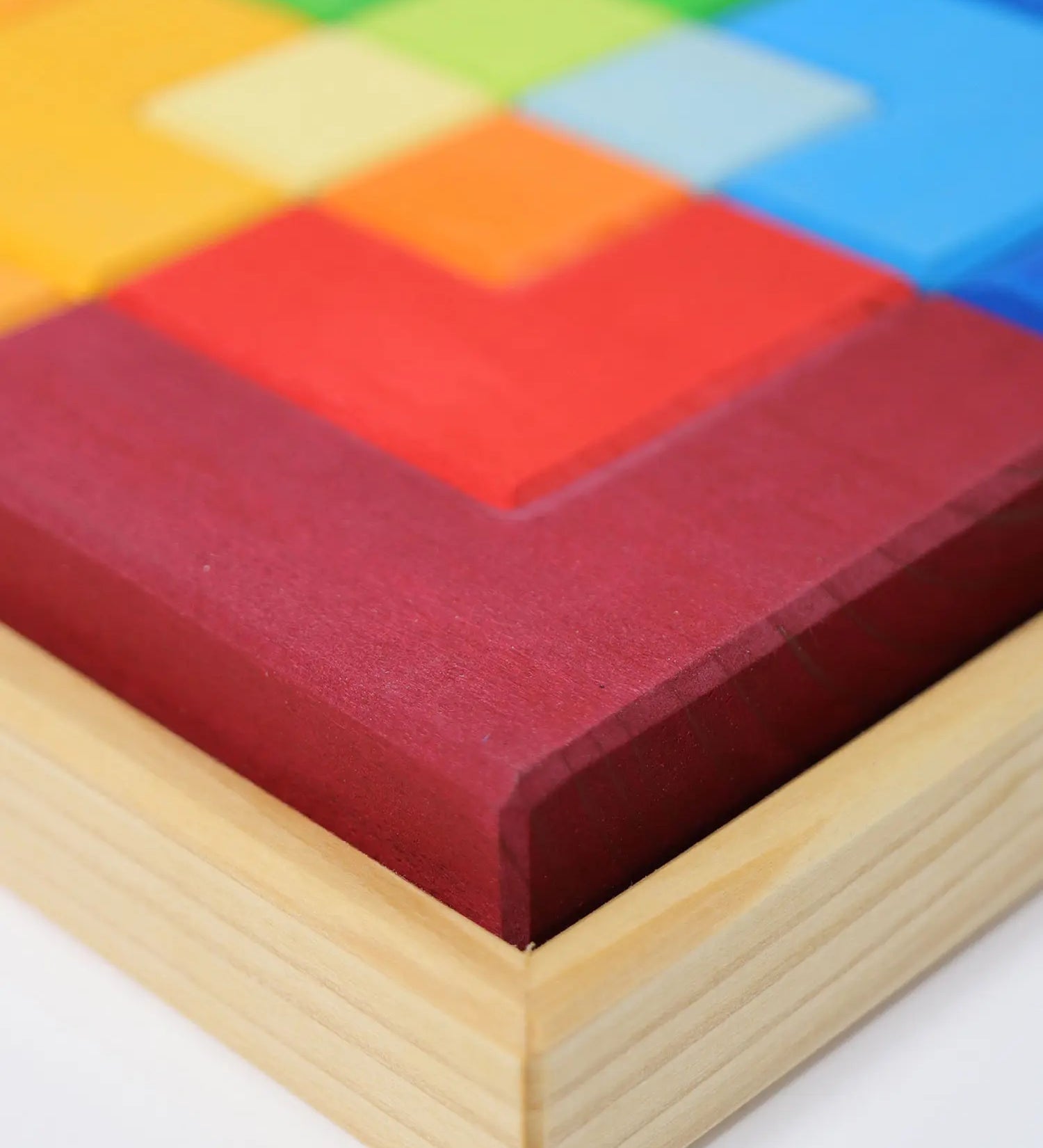 Close up of the Grimm's large creative puzzle square wooden toy in a wooden storage display tray. 