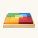 Side view of the Grimm's large creative puzzle square wooden toy in a wooden storage display tray. 