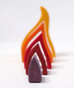 Grimms handcrafted wooden fire set showing each flame piece lined up from small to large