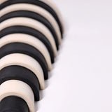 Close up of the Grimm's large monochrome 12 piece rainbow.