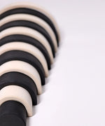 Close up of the Grimm's large monochrome 12 piece rainbow.