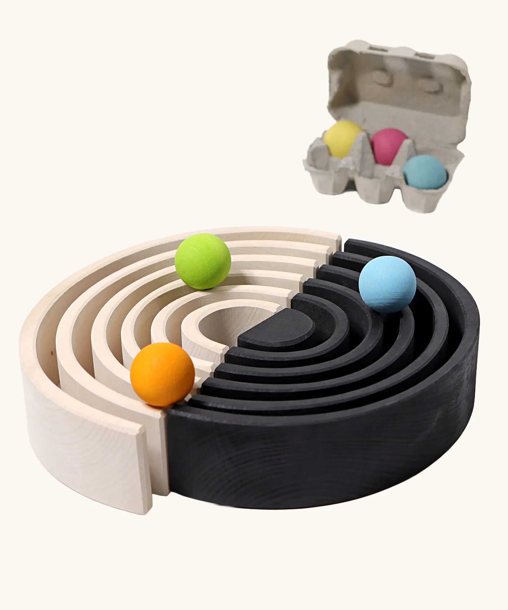 Grimm's large monochrome 12 piece rainbow set up as a ball run with Pastel Grimm's wooden balls.