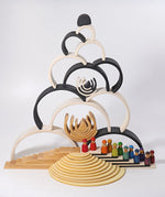 Grimm's large monochrome 12 piece rainbow stacked u along with other Grimm's rainbows, building boards, semi circles and friends peg dolls. 