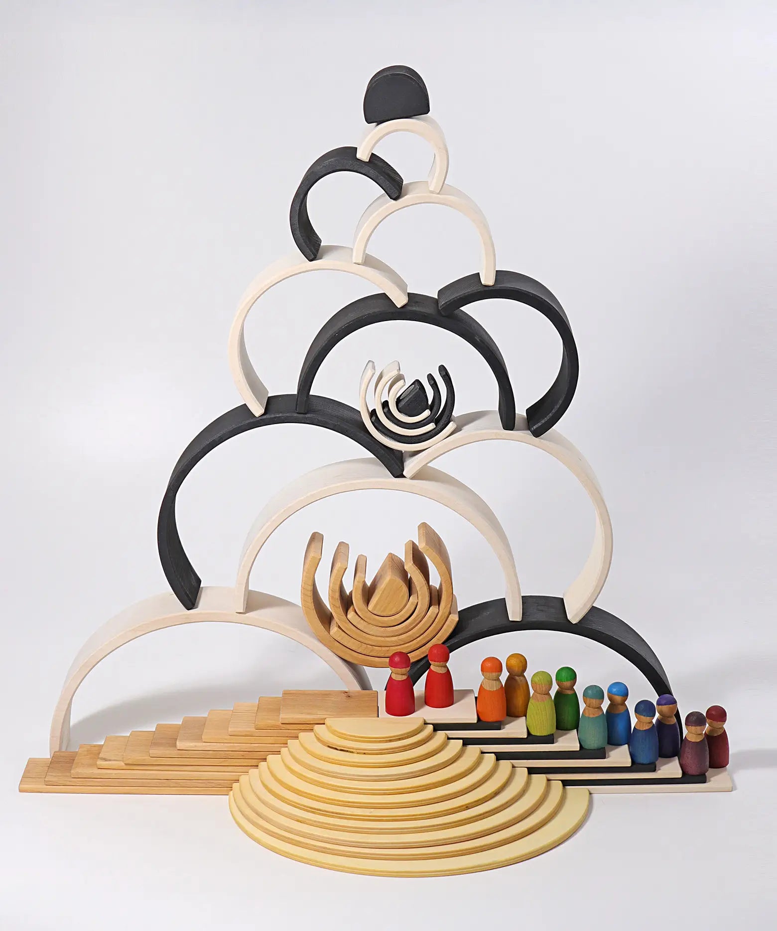 Grimm's large monochrome 12 piece rainbow stacked u along with other Grimm's rainbows, building boards, semi circles and friends peg dolls. 