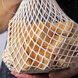 Grimm's large wooden natural building blocks set in it's string storage bag.