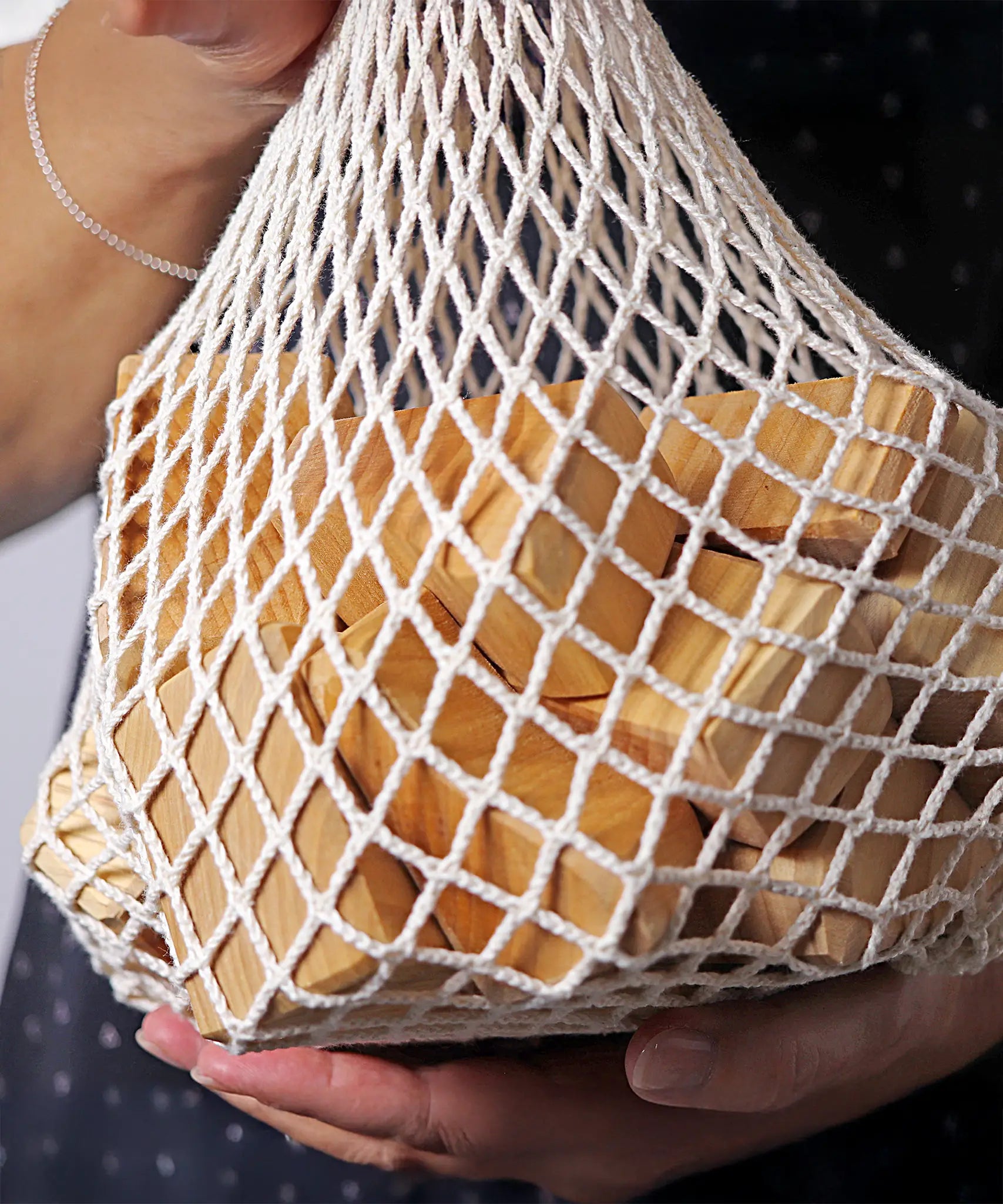 Grimm's large wooden natural building blocks set in it's string storage bag.