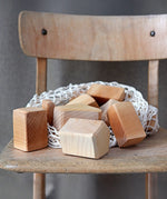 Grimm's large wooden natural building blocks set placed on a wooden chair.