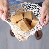 Grimm's large wooden natural building blocks set in their string storage bag .