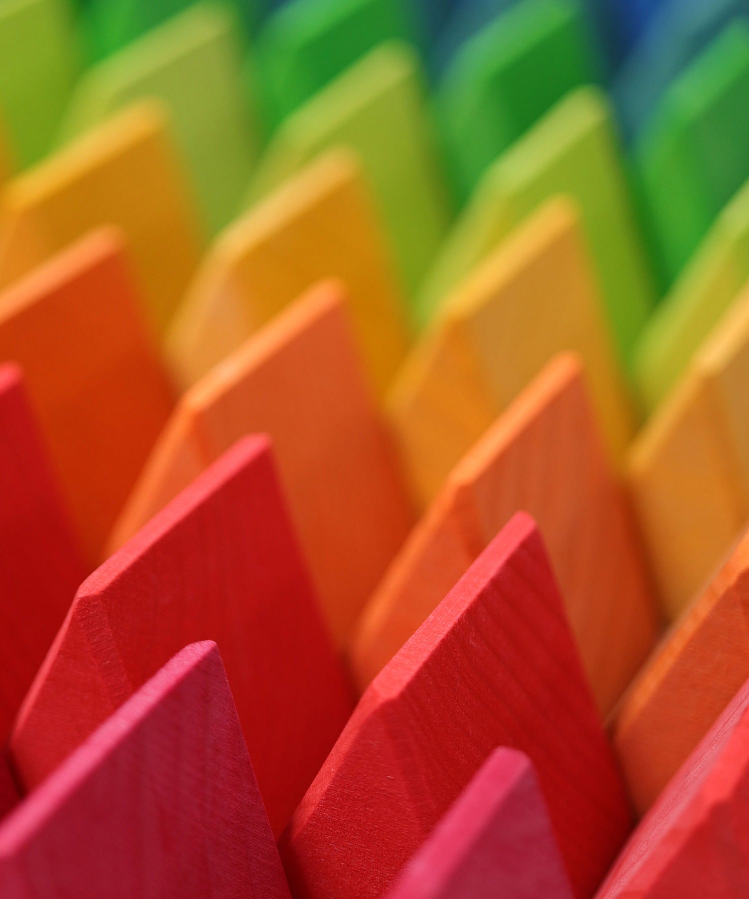 A close up of the triangle shaped wooden blocks from the Grimm's Large Octagon Puzzle. 