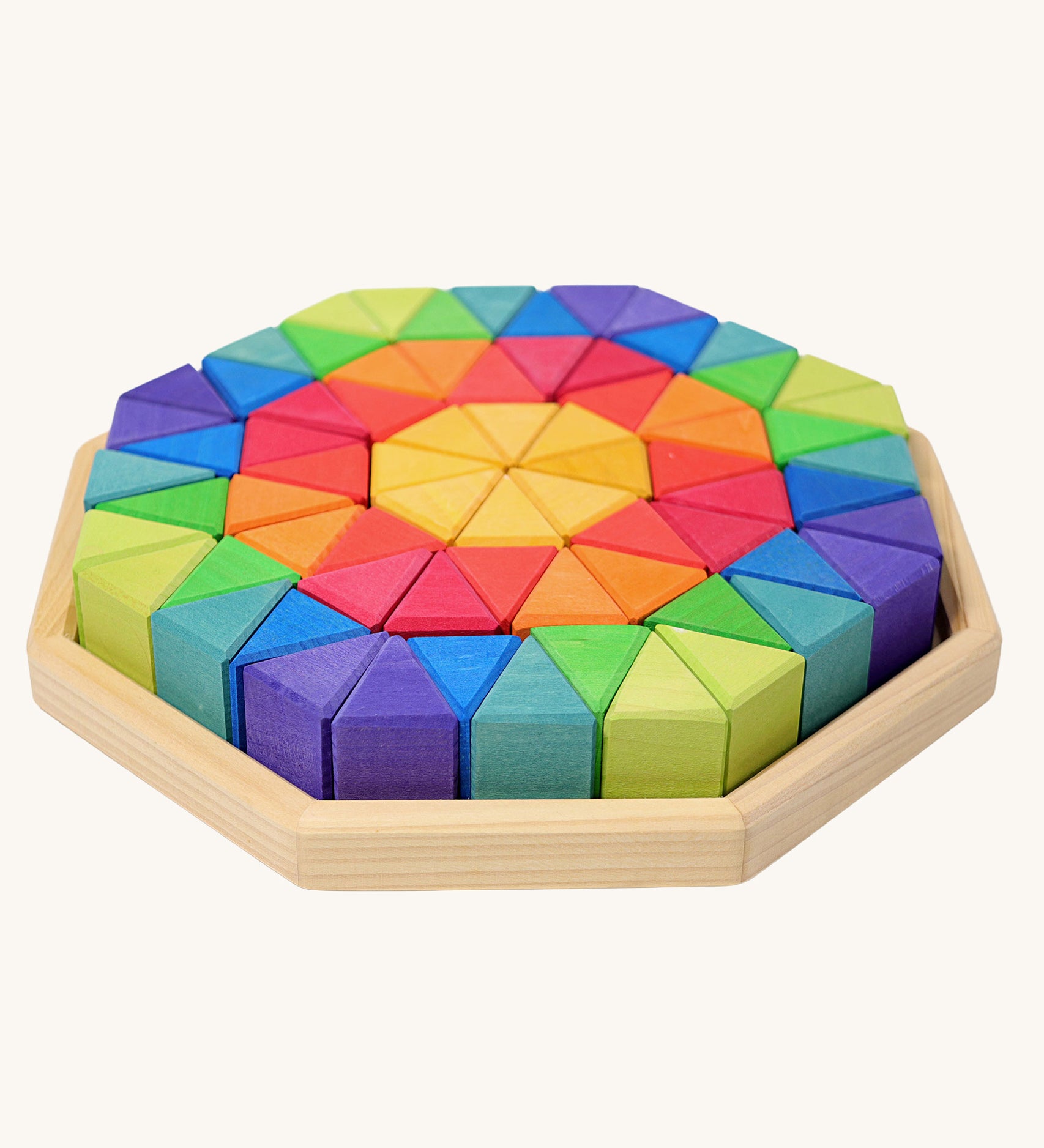 Grimm's Large Octagon Wooden Puzzle set containing rainbow coloured triangular shaped blocks in a wooden storage tray. 