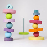 A balancing game using pieces from the Grimms large conical tower in pastel colours and wooden balls