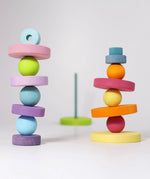 A balancing game using pieces from the Grimms large conical tower in pastel colours and wooden balls
