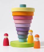 Grimms large conical tower in pastel colours showing a stack inverted on the base with peg dolls standing near 